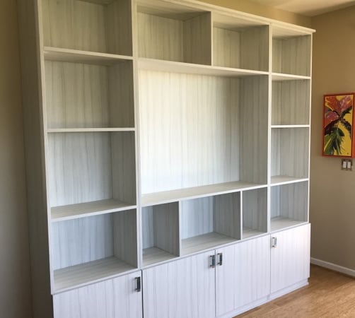 White entertainment center with cubbies and cabinets