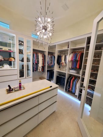 White walk-in closet system with center island and shoe storage California Closets Pensacola and Panama City, Florida
