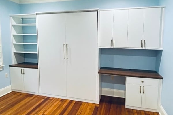 Murphy bed in a wall with desk and bookshelves California Closets New Orleans & Gulf Coast