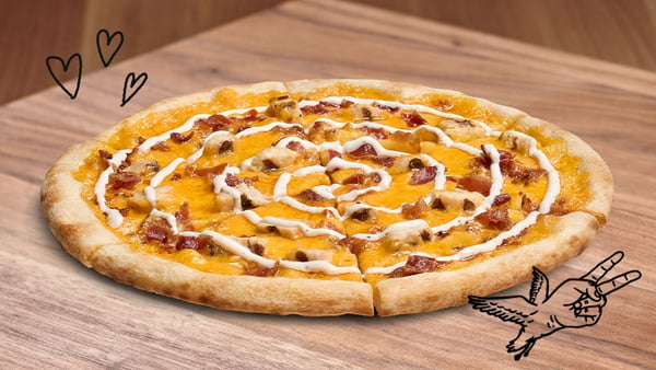 Chicken Bacon Ranch pizza on a wood table.