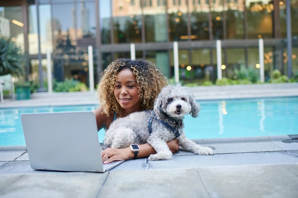 Woman on laptop in pool