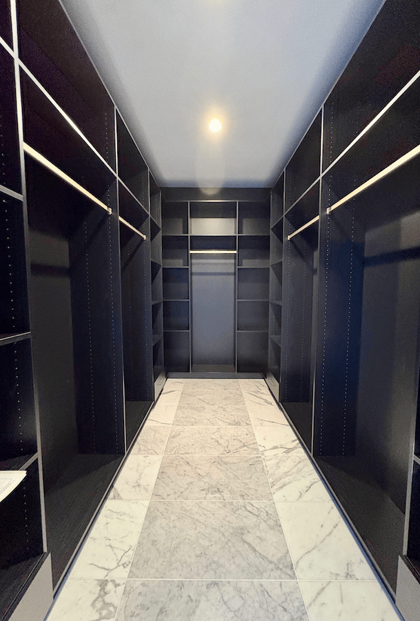 black custom walk in closet with hanging rods and shelves in Bloomfield Hills, MI.