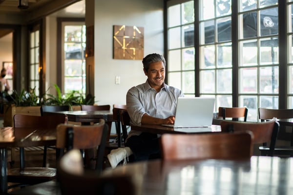 Man on laptop in a restaurant