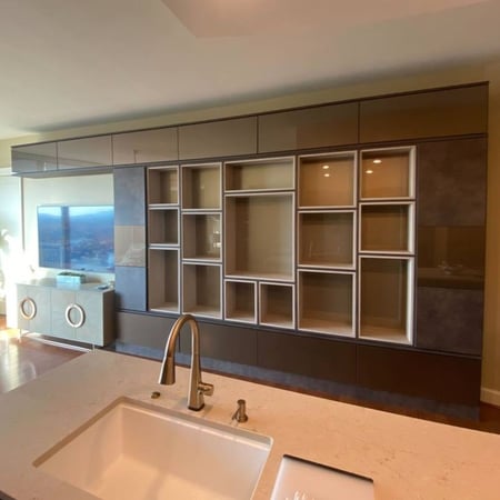 Richmond - Custom closets - Living room entertainment center covering the entire wall with cabinets and cubbies