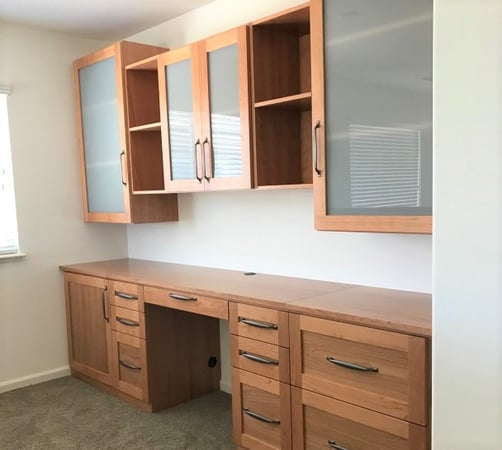 Desk and cabinets in Cherry wood veneer with semi-opaque glass inserts.