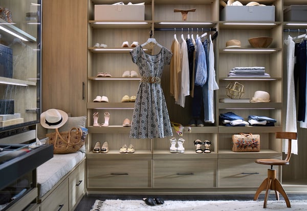Light wood walk-in closet with lighting by California Closets Norwalk, Connecticut.