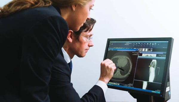 Radiologist and consultant reviewing scan