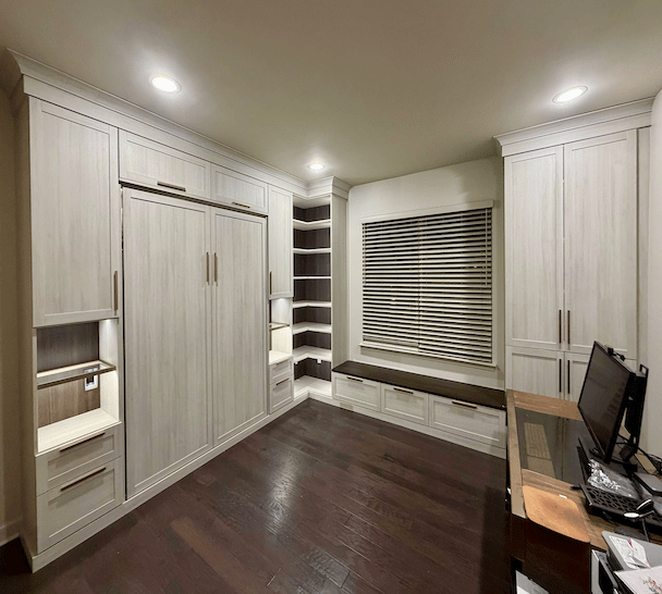Wall bed with light wood, shelving, drawers, and a desk