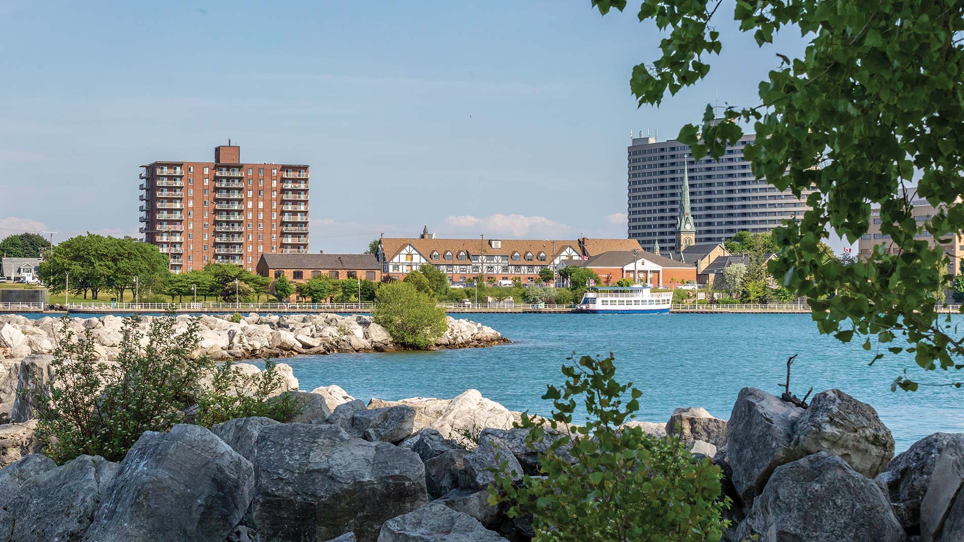 Looking past a rock wall to the Sarnia skyline.