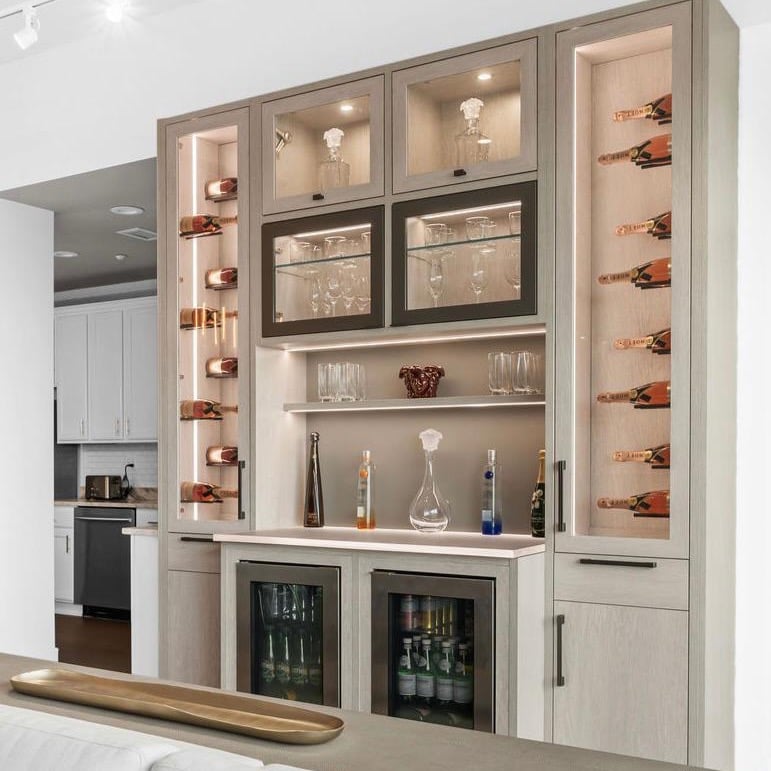 Natural tone wine bar with clear glass doors and lights by California Closets Greater Detroit, Michigan.