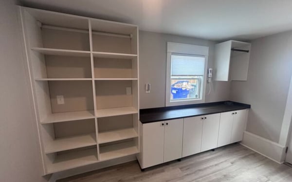 Wilmington - Custom closets - Contemporary mudroom or utility room with shelving, cabinets, and black countertop.