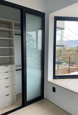 Reach-in closet with shelves, drawers, hanging area by California Closets Pasadena.