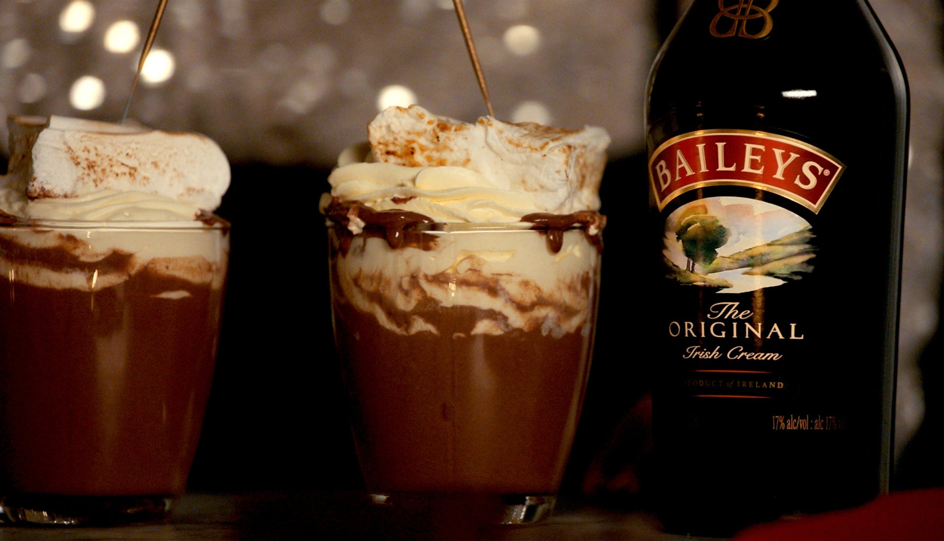 Two glasses with hot chocolate and a bottle of Baileys Original Irish Cream