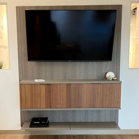 Sleek floating media center with small bookcase and bookshelves California Closets Pensacola and Panama City, Fl