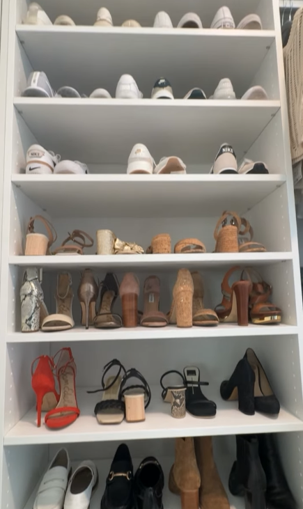 Wall-to-ceiling white shoe rack.