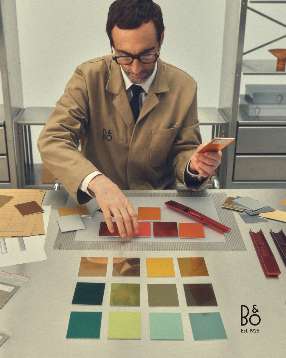 A man looking at different material options for customising speakers