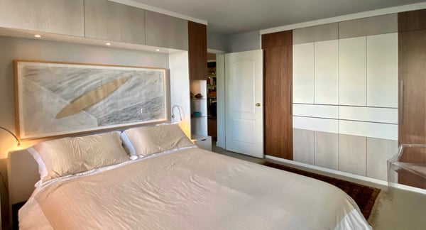 wide view showing most of the bed surround storage and flush wardrobe