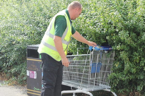 Man pulling a trolley out of a bush