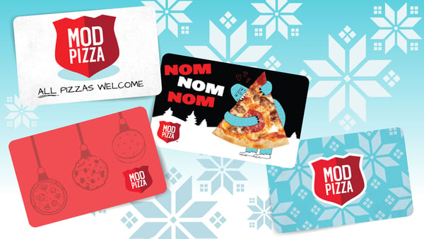 4 MOD Pizza Gift cards  with different winter themed designs sit on a light blue background with snowflakes.