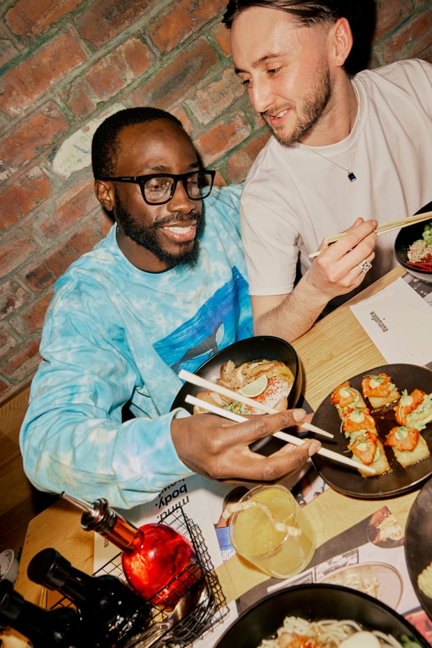 two men eating shareables at wagamama