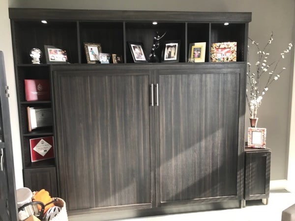 Custom storage solutions with custom lighting featuring a Murphy Bed by California Closets Columbus in Columbus, Ohio.