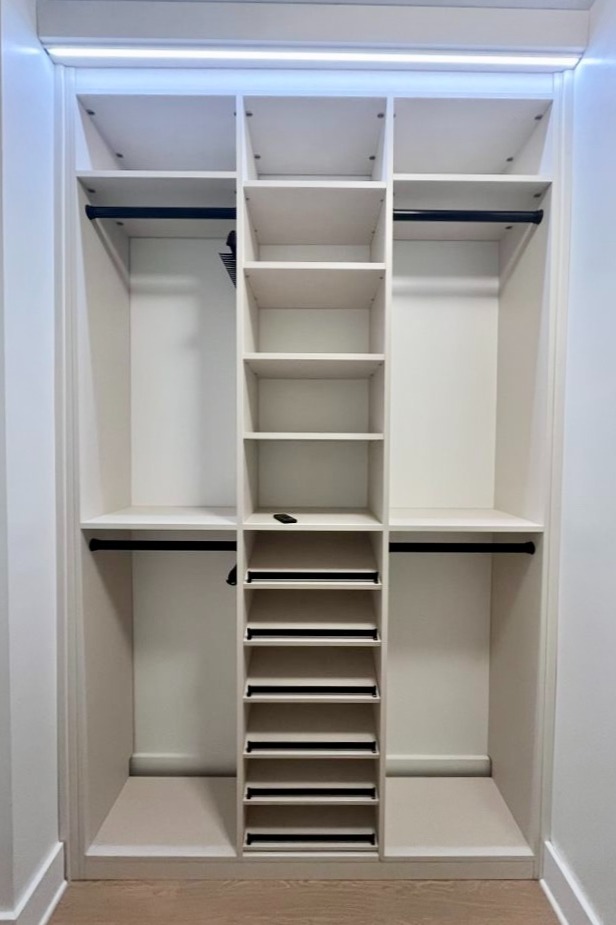 Reach in closet organization with closet lighting and shoe organization California Closets Pensacola & Panama City, FL