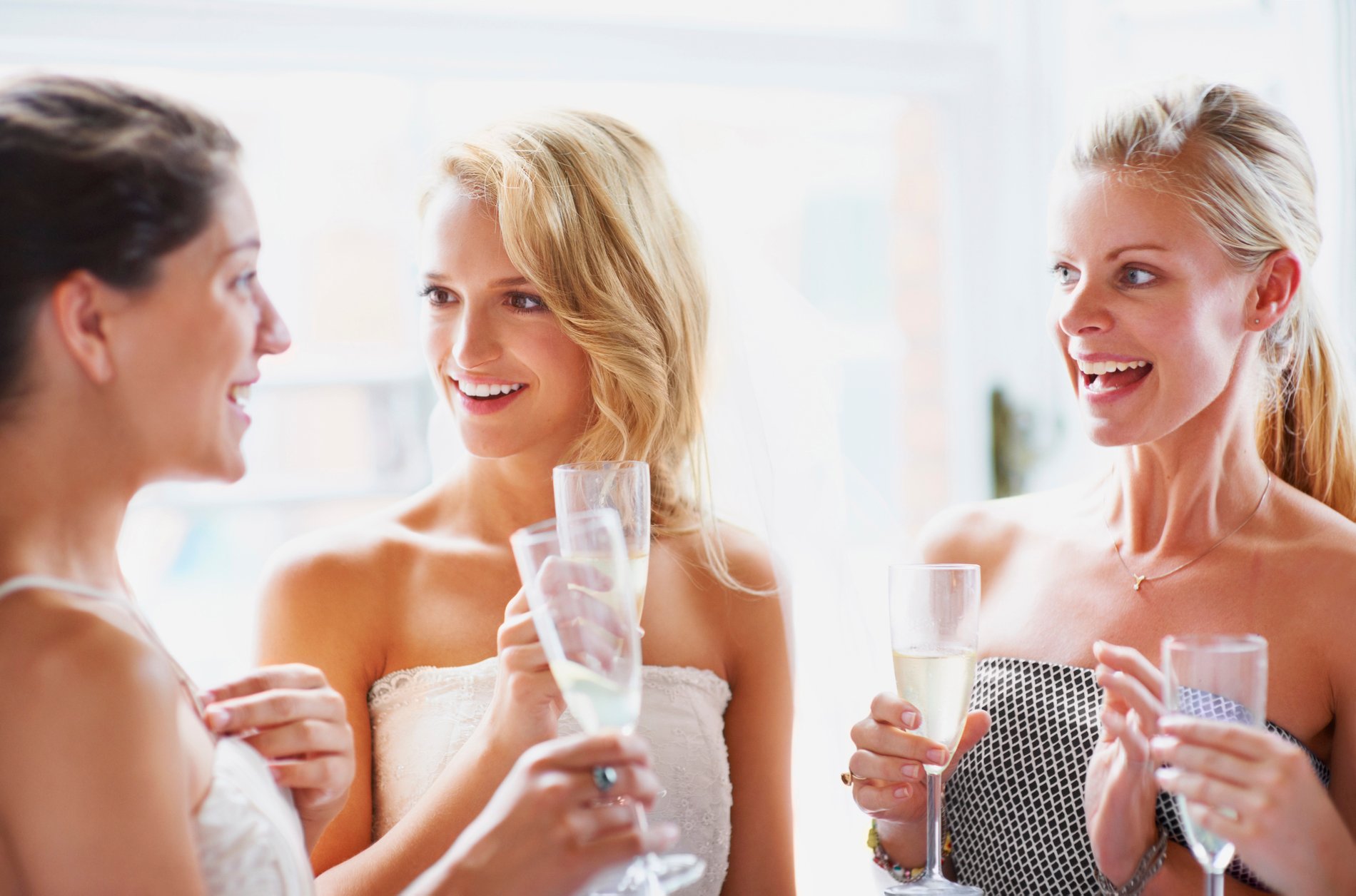 Bride with her bridesmaids having a champagne toast.