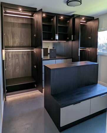 Gorgeous black walk-in closet with center island and lights