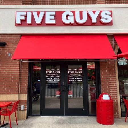 Exterior photograph of the Five Guys restaurant at 11900 Shawnee Mission Parkway in Shawnee, Kansas.