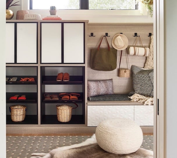 Two Tone Mudroom with brown and black tones, hooks and a bench by California Closets Northern Michigan