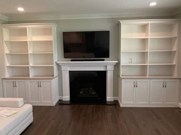 Richmond - Custom closets - Living room built-in bookshelves around TV and fireplace