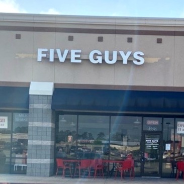Exterior photograph of the Five Guys restaurant at 507 I-45 in Conroe, Texas.