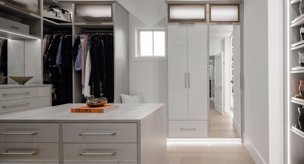 California Closets Rockland County NY Custom White and  Gray Walk in Closet Luxury Modern Walk in Closet High Gloss White drawers Vanity with Mirror LED Lighting custom shelving custom center island