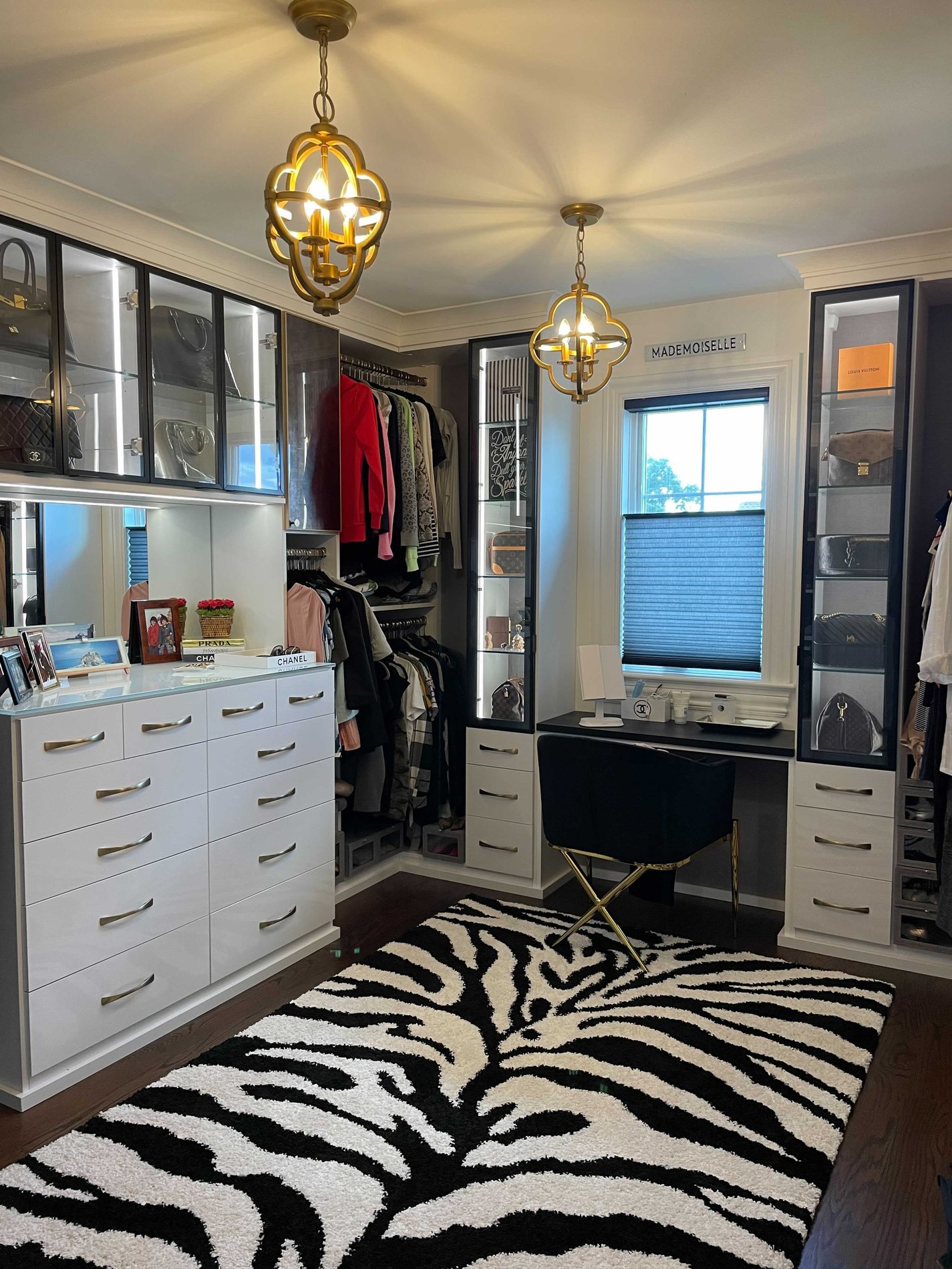 Walk-in closet in black and white with animal print rug