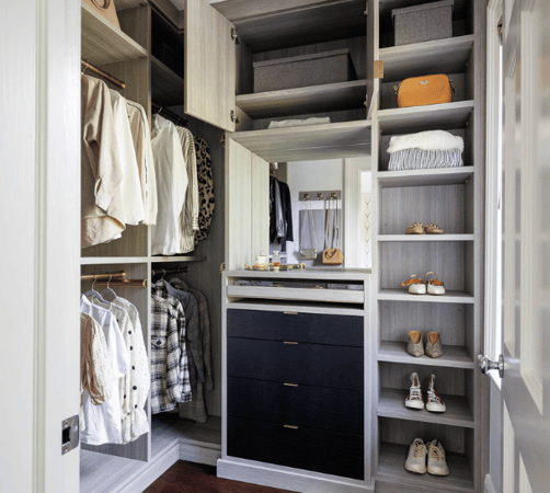California Closets Westchester New York Small Walk-in Closet with Open Storage double hanging shoe shelving black leather drawers, custom mirror and jewelry drawers