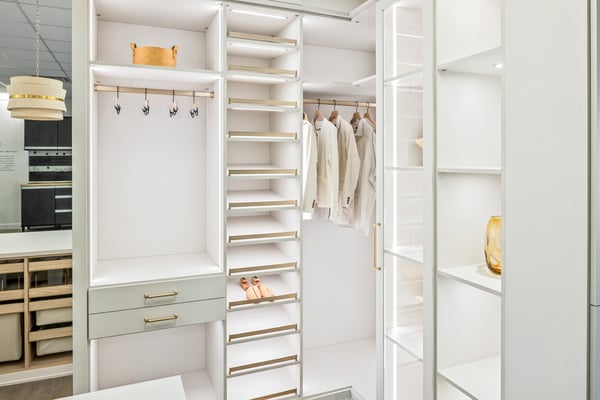 Clothing and shoe racks with adjacent open shelving in classic white finish