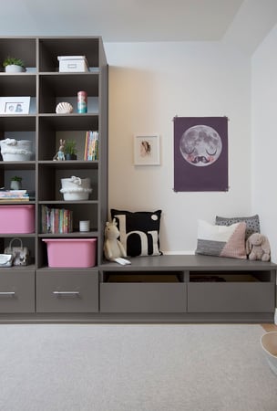 Custom storage with built-in shelving, drawers and bench seating for organized books, toys and everyday essentials in a kids’ room. California Closets, Greater Detroit