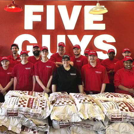Crew members pose for a photograph in the dining room ahead of the grand opening of the Five Guys at 821 West Clairemont Avenue in Eau Claire, Wisconsin.