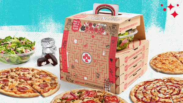 The Fundle a Family Bundle with a Mega sized Salad, four create-your-own pizzas, and four no-name cakes. The box that the Fundle is in displays a maze on one side of the box and other fun games.
