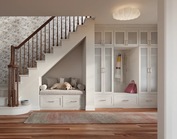 Light-toned entryway closet with bench under stairs by California Closets Norwalk, Connecticut.