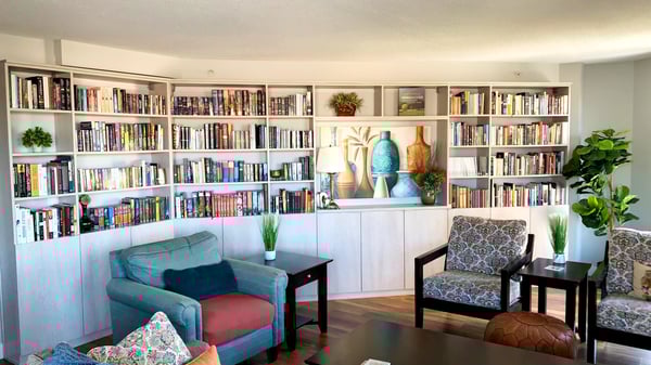 Bookshelves and lower cabinets built at an angle to accommodate the room shape