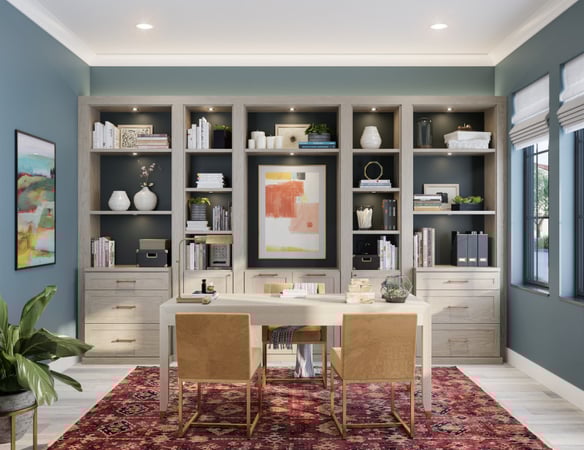 Custom home office in Austin featuring a freestanding desk, built-in custom cabinetry for display and organization, file drawers, small storage drawers, and workspace in a light gray woodgrain finish by California Closets.