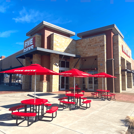 Exterior photograph of the entrance to the Five Guys restaurant in Grand Prairie, Texas.