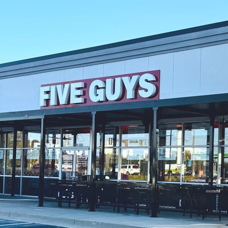 Exterior photograph of the Five Guys restaurant at 908 Buford Highway in Cumming, Georgia.