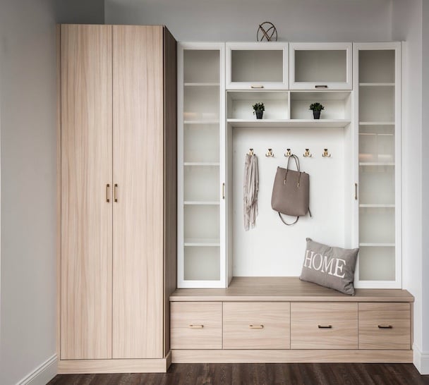 Custom mudroom storage with built-in bench, coat hooks, and upper cubbies.