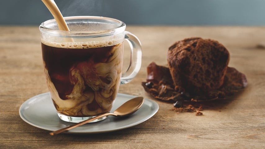 Baileys being poured into a cup of coffee