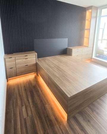 A unique one of a kind project. Custom designed bed with storage on either side and black tambour paneling on the wall. Built in lighting elevates this design even further.