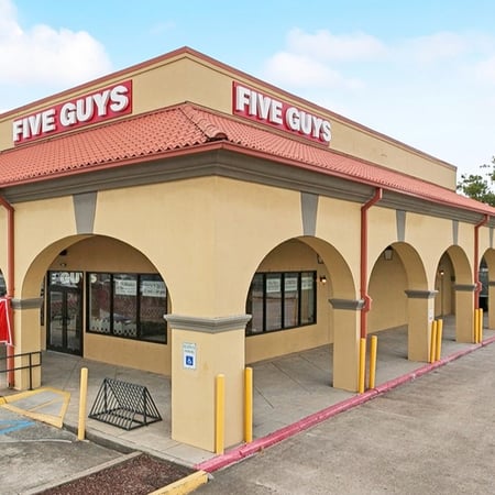 Exterior photograph of the Five Guys restaurant at 5300 Tchoupitoulas Street in New Orleans, Louisiana.