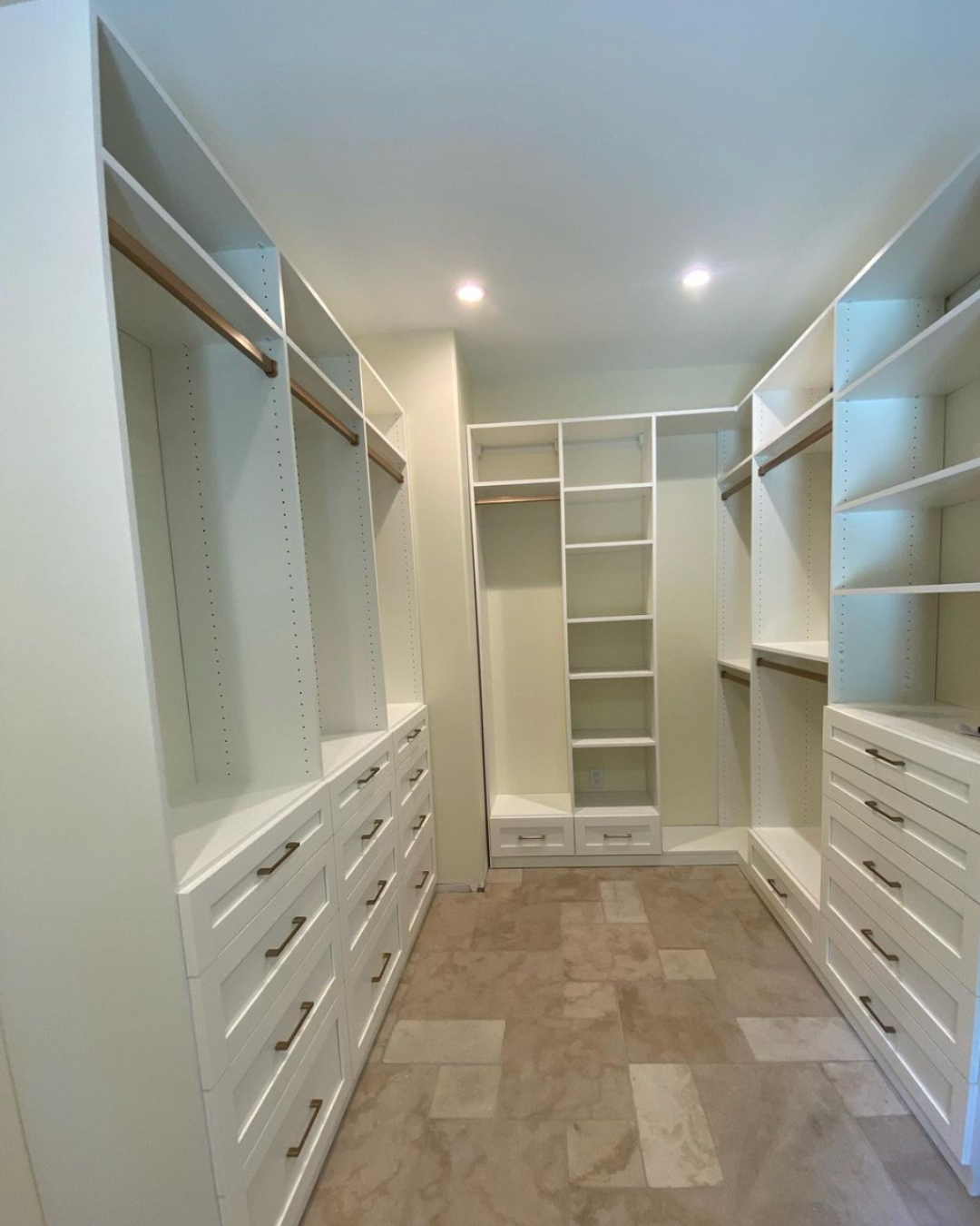 Luxe white walk-in closet with gold finishes