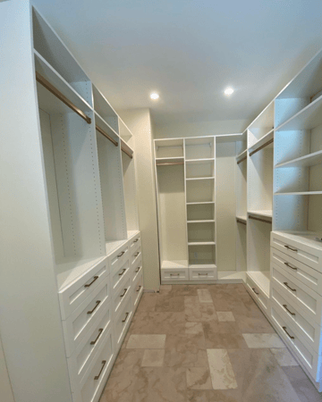 Luxe white walk-in closet with gold finishes